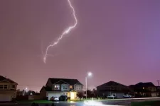 Houses with garage doors. Thunder and strike storm